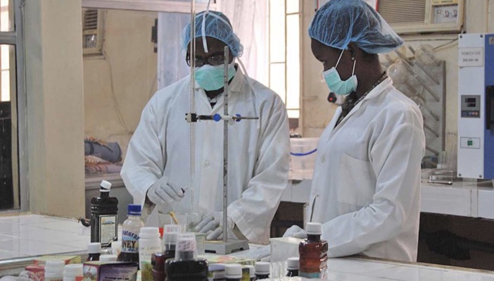 Yemkem laboratory scientists working at the bench in PPE